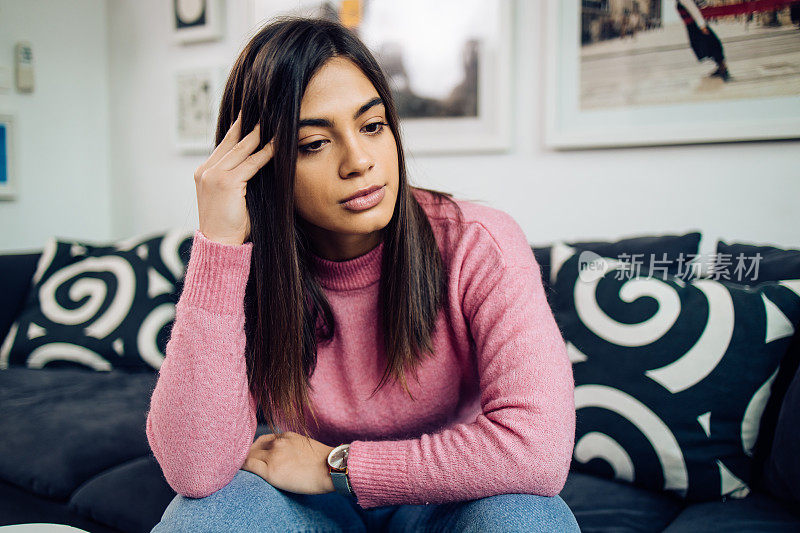 Portrait of a girl sitting at home and thinking